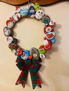 a christmas wreath made out of buttons hangs on the wall