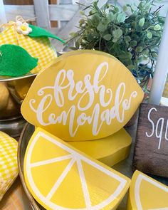 some lemon slices are sitting on a table with a sign that says fresh lemonade