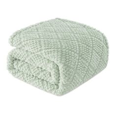 a green blanket on top of a white background