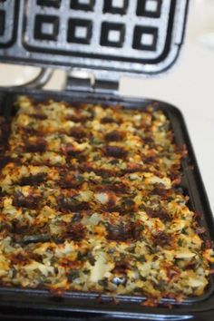 a pan filled with food sitting on top of a stove next to an air fryer