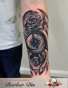 a man's arm with a clock and roses on it