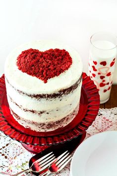 a heart shaped cake sitting on top of a red plate