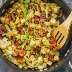 a skillet filled with cooked vegetables on top of a table