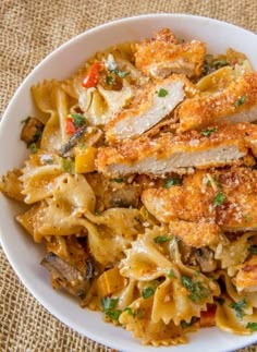 a white bowl filled with pasta and chicken