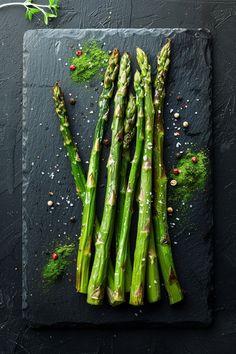 Freshly grilled asparagus seasoned with salt, pepper, and herbs on a dark slate serving board. Recipes For Asparagus, Healthy Asparagus, Asparagus Recipes Oven, Recipes To Try At Home