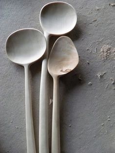 four spoons are lined up on the floor