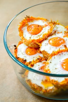 three fried eggs are in a glass bowl