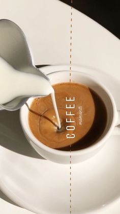 a spoon pouring milk into a cup of coffee on top of a white saucer