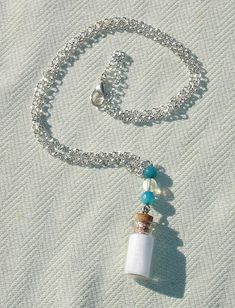 This mini glass spell bottle measures 3/4". It features blessed salts. Necklace measures 21" length. Features Mystic aura quartz and dragons vein agate gemstone beads! Silver Hair Comb, Wiccan Witch, Dragon Vein Agate, Witch Books, Aura Quartz, Agate Gemstone, Handmade Accessories