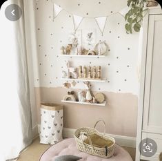 a baby's room decorated in pink and white