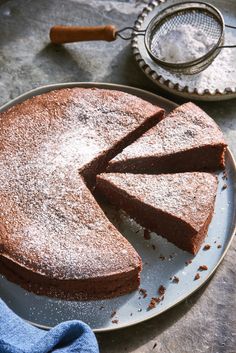 a chocolate cake on a plate with one slice cut out