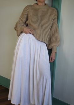 The Laurel Hemp Jersey Skirt boasts a remarkable fabric that combines the softness of a well-loved vintage t-shirt with the distinct texture of hemp. This versatile skirt is a must-have staple for effortless pairings with any item in your wardrobe. It features a bias cut for a refined touch, along with convenient side pockets and a chic drape, all secured with a simple elastic waistband and natural-hued woven cord. Made in USA Hemp Clothing, House Clothes, Jersey Skirt, Knit Outerwear, Curated Vintage, Clothing Line, Dress Suits, Vintage Cotton, Toddler Dress