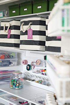 the shelves are filled with different types of storage bins and boxes for crafting