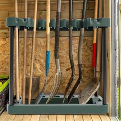 several different types of baseball bats in a storage area