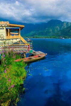 a house sitting on top of a small island in the middle of a body of water