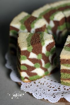 there is a cake with green and brown frosting on the top, cut in half