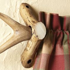 the antlers are hanging on the wall next to the plaid blanket and pillow cover