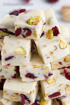 a pile of white chocolate with cranberries and pistachios