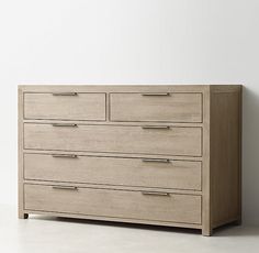 a large wooden dresser sitting on top of a white floor