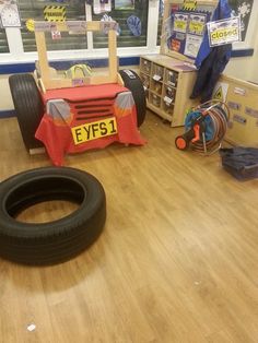 a room with toys and other items on the floor, including an inflatable car