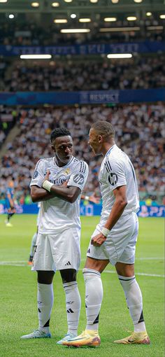 two soccer players are standing on the field