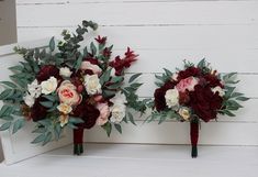 two bridal bouquets sitting on top of a white bench next to each other