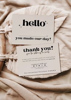 two business cards with the words hello and you made our day written in black on them