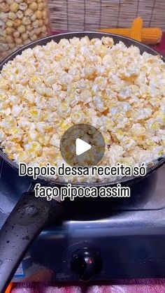 a bowl filled with popcorn sitting on top of a stove