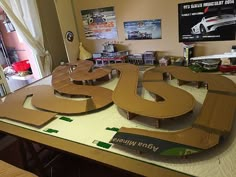 a table that has some type of car on top of it with the letters s and t cut out