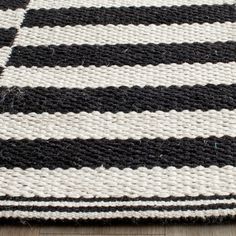 a black and white striped rug on the floor