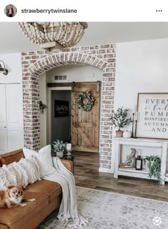 a living room filled with furniture and a wooden door in the middle of it's wall