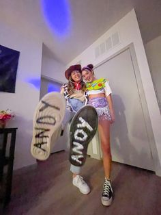 two young women are posing with their skateboards