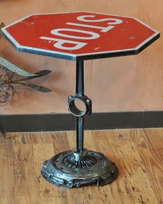 a red stop sign sitting on top of a wooden floor