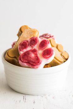 a close up of a bowl of food with dog paw prints on the top and bottom