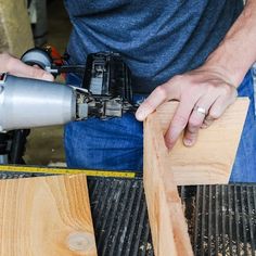 a man using a drill to cut wood