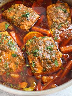 some meat and carrots are in a pot with broth on the side, ready to be eaten