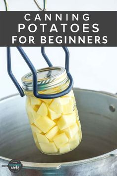 a mason jar filled with potatoes sitting on top of a metal pan and text overlay that reads how to can potatoes for beginners