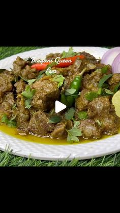 a white plate topped with meat covered in sauce and garnished with cilantro