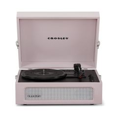 the crosley record player is pink and has a black vinyl disc in it