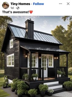 a small black house with white trim and windows on the front porch is featured in an instagram for tiny homes