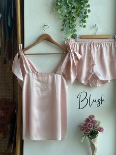 These days, more brides are moving away from traditional robe options for getting ready and are looking for unique gifts like pjs for their bridesmaids. The bride in the above picture chose Rose Quartz for her bridesmaids and White for herself. Style We have several different styles of Pj sets available. The photo you see above is of Tie Ribbon Tank Top style Pj set.  We offer these pajama sets in both long and short versions. The long version, which includes pants, exudes a comfy and peaceful v Lounge Wear Bridesmaids, Wedding Party Pjs, Pjs For Bridesmaids, Bridesmaids Pajamas, Pink Sets, Pink Pajama Set, Bday Brunch, Pink Pjs, Bridesmaids Getting Ready