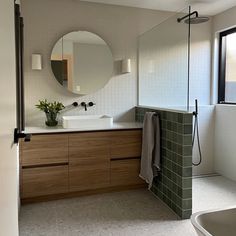 a bathroom with a sink, mirror and bathtub