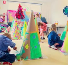 the instagram page shows children playing with paper cones and other crafting materials in an art class