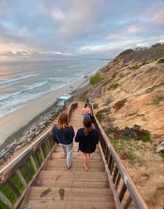 two women walking up stairs to the beach