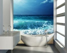 a bathtub sitting in the middle of a bathroom next to a window with an ocean view