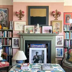 a living room filled with furniture and bookshelves covered in pictures on the wall