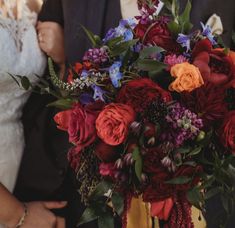 the bride and groom are holding their bouquets