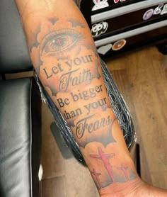 a person with a tattoo on their arm that says let your faith be bigger than your fears