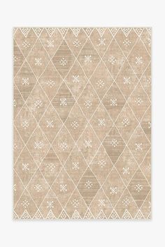 a beige and white rug with diamond shapes on it