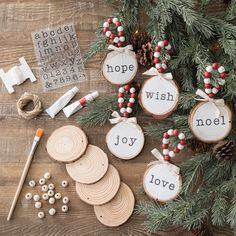 christmas ornaments are arranged on a table with wood slices and other crafting supplies around them